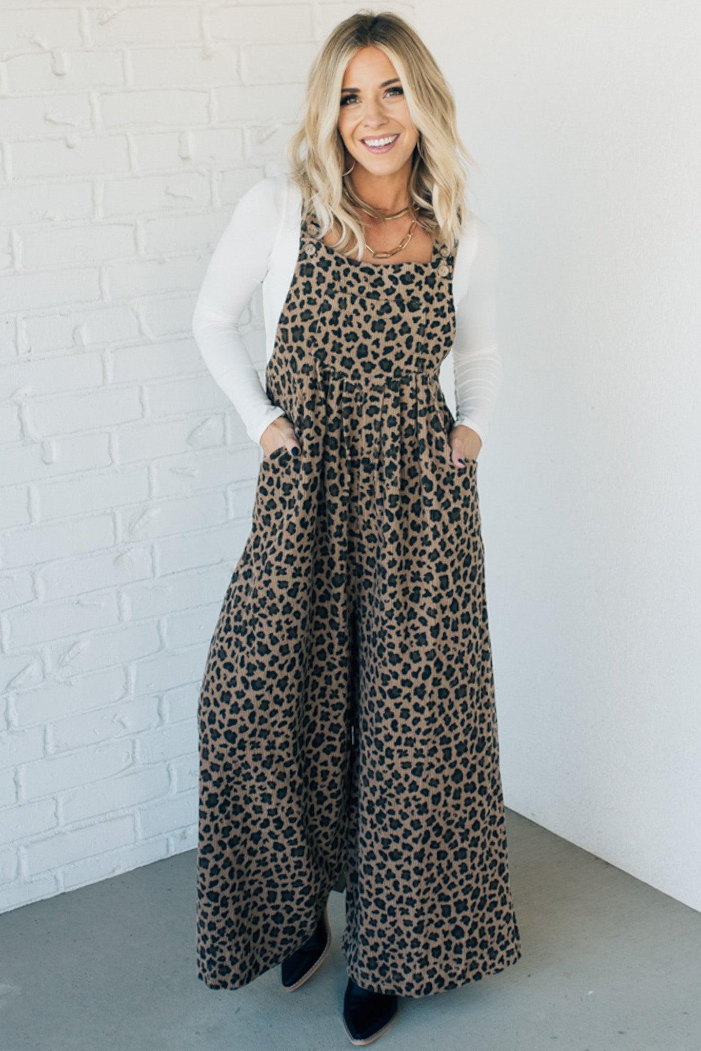 Blonde woman wearing wide leg overalls with all over leopard print and corduroy texture.