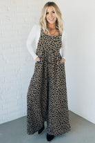 Blonde woman wearing wide leg overalls with all over leopard print and corduroy texture.