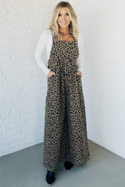 Blonde woman wearing wide leg overalls with all over leopard print and corduroy texture.