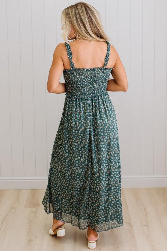 Woman wearing a green floral dress with a white background
