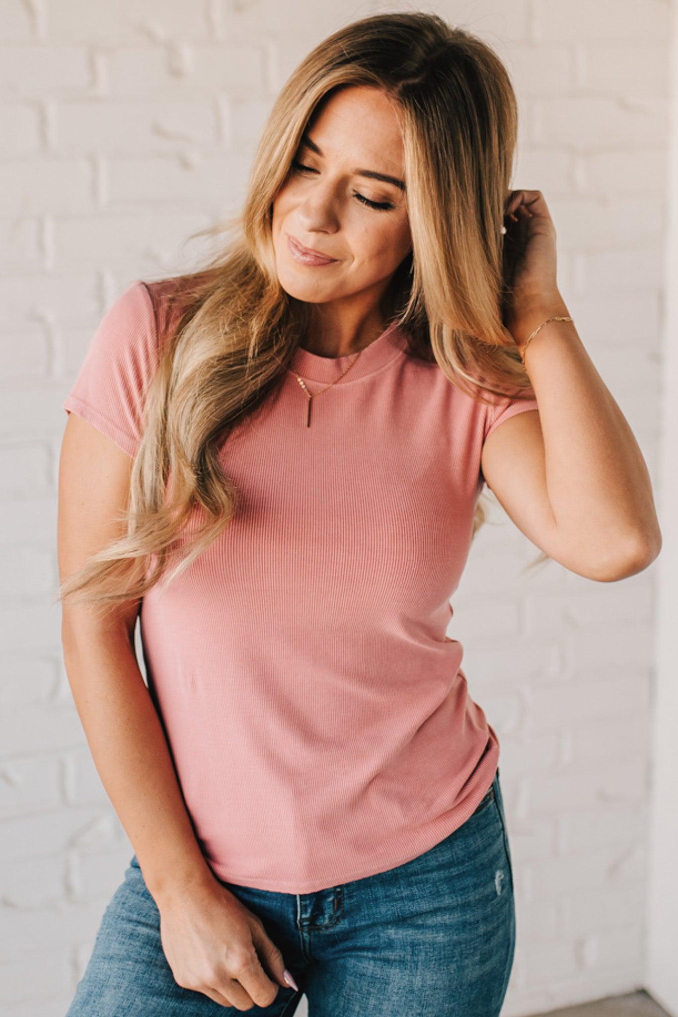 Blonde woman wearing a basic slim fit ribbed tee shirt.