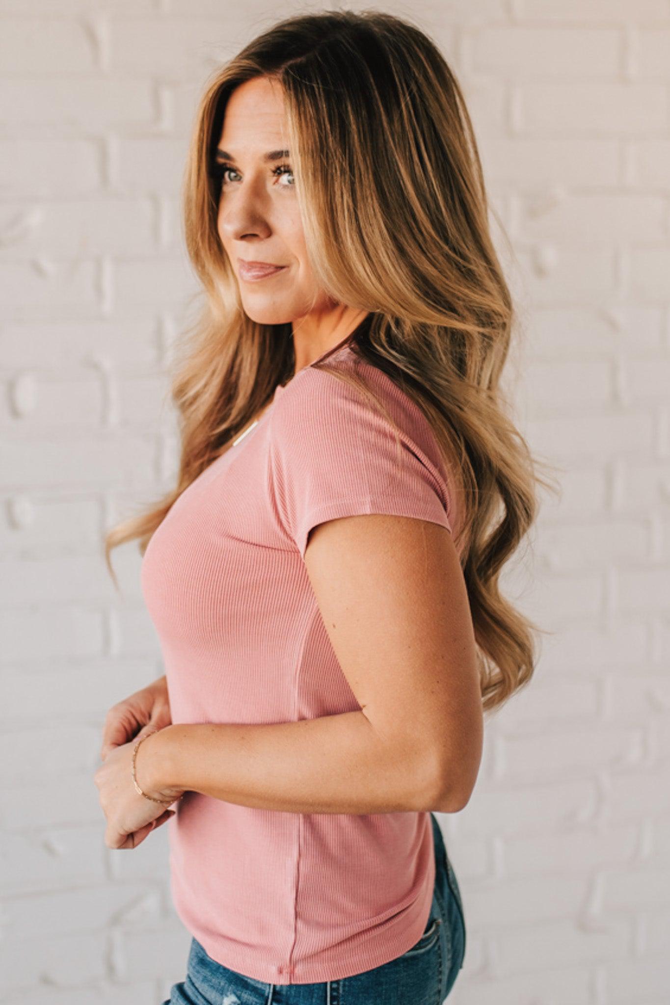 Blonde woman wearing a basic slim fit ribbed tee shirt.