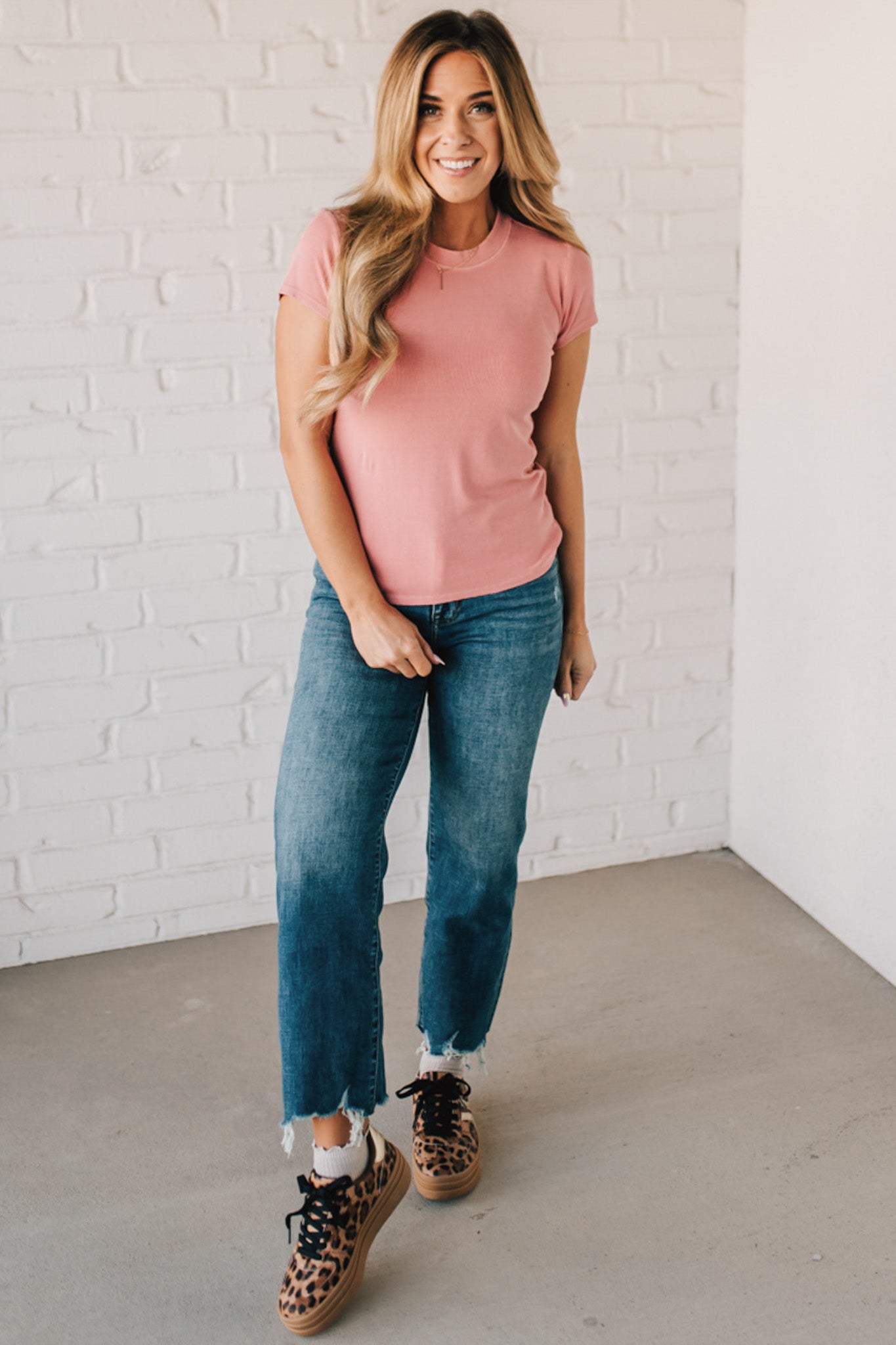 Blonde woman wearing a basic slim fit ribbed tee shirt.