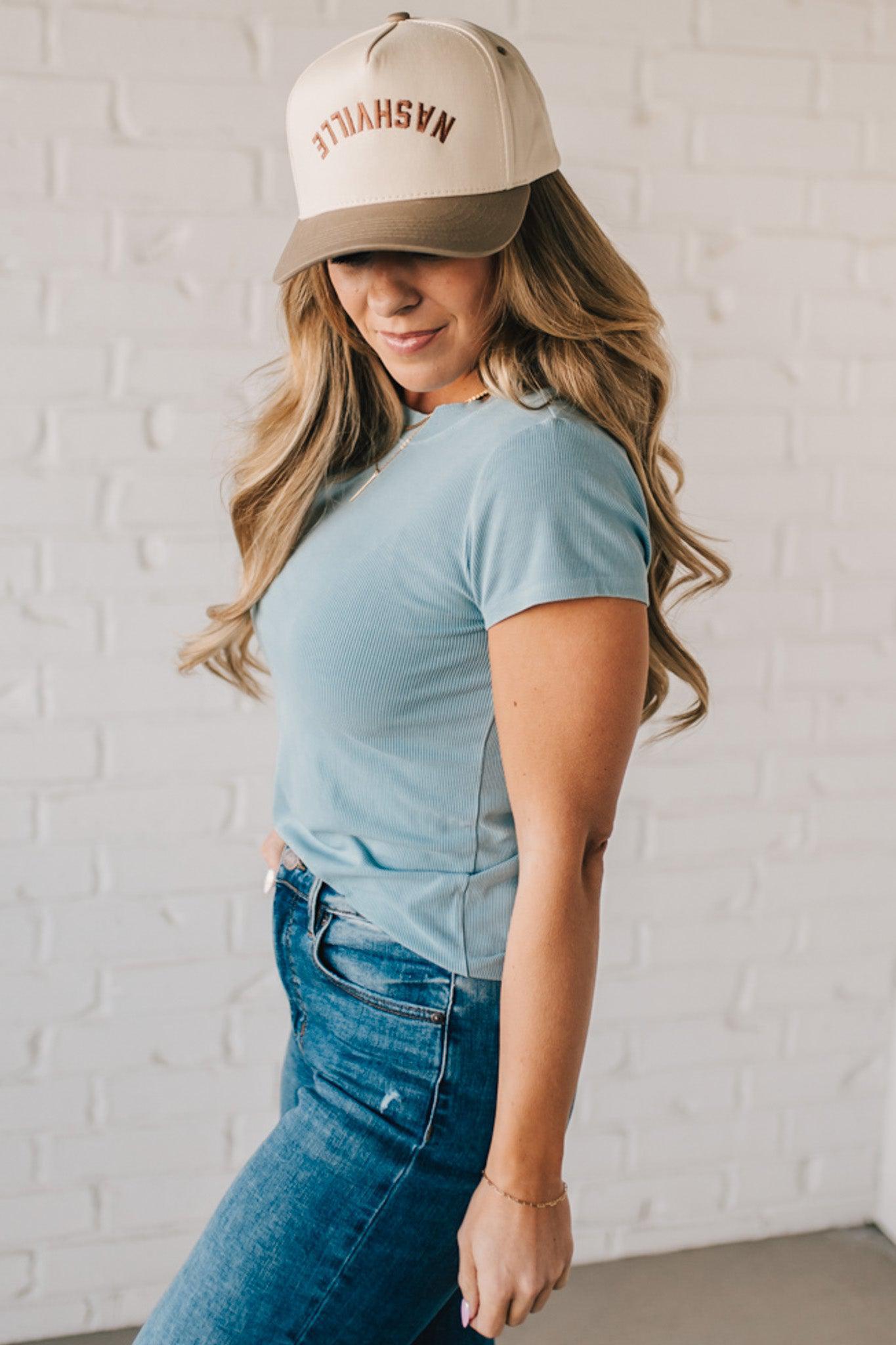 Blonde woman wearing a basic slim fit ribbed tee shirt.