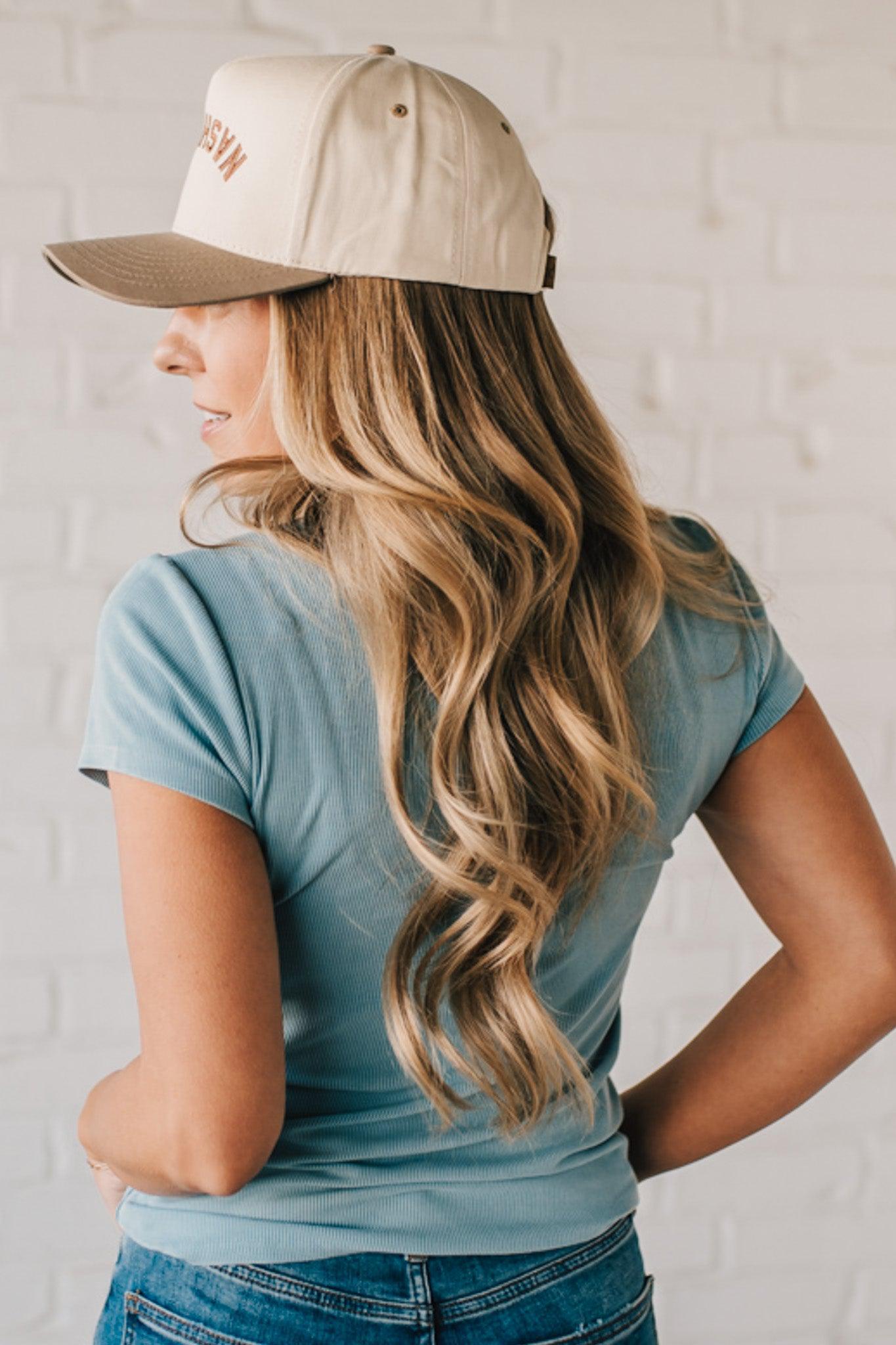Blonde woman wearing a basic slim fit ribbed tee shirt.