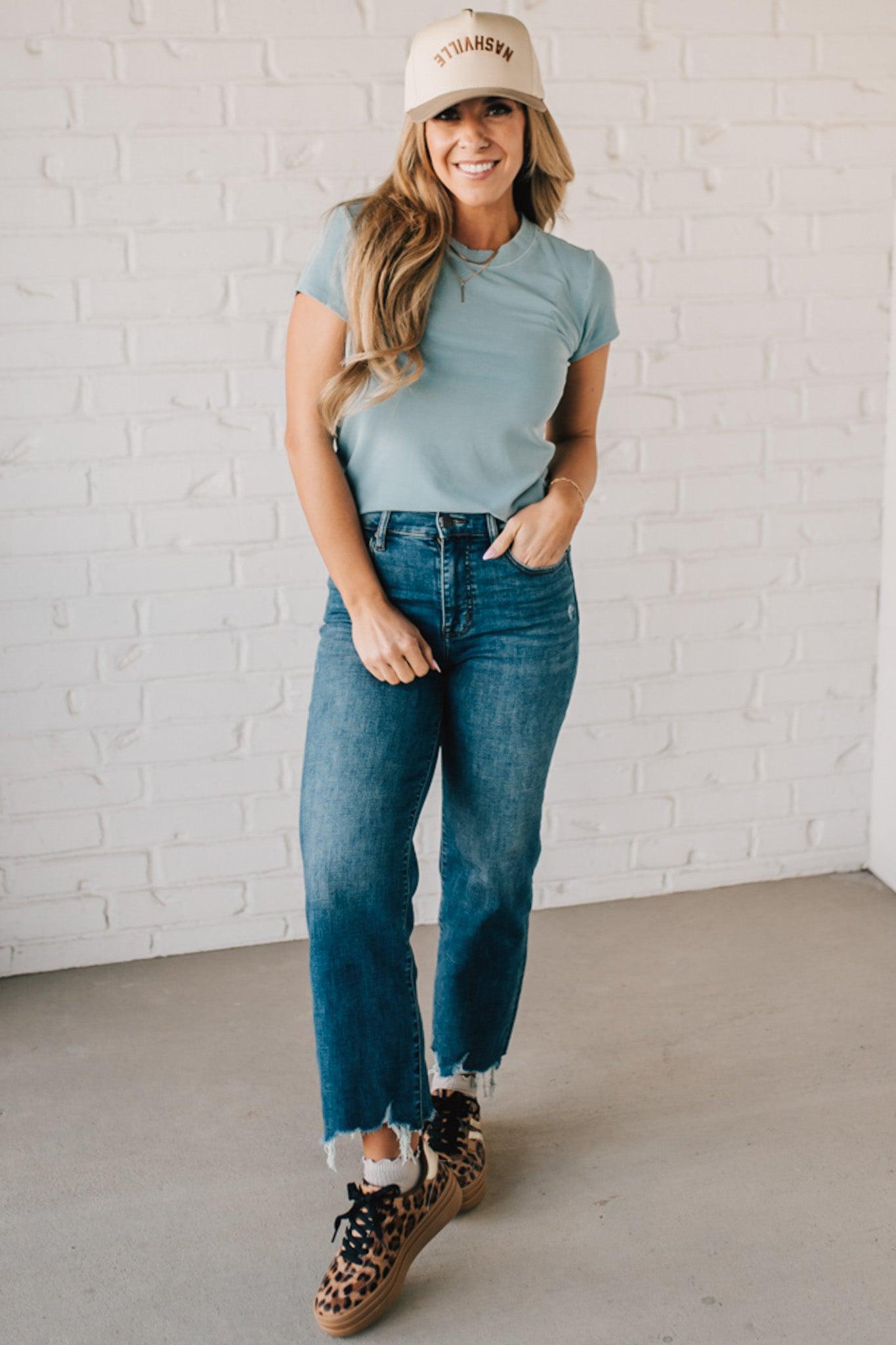Blonde woman wearing a basic slim fit ribbed tee shirt.