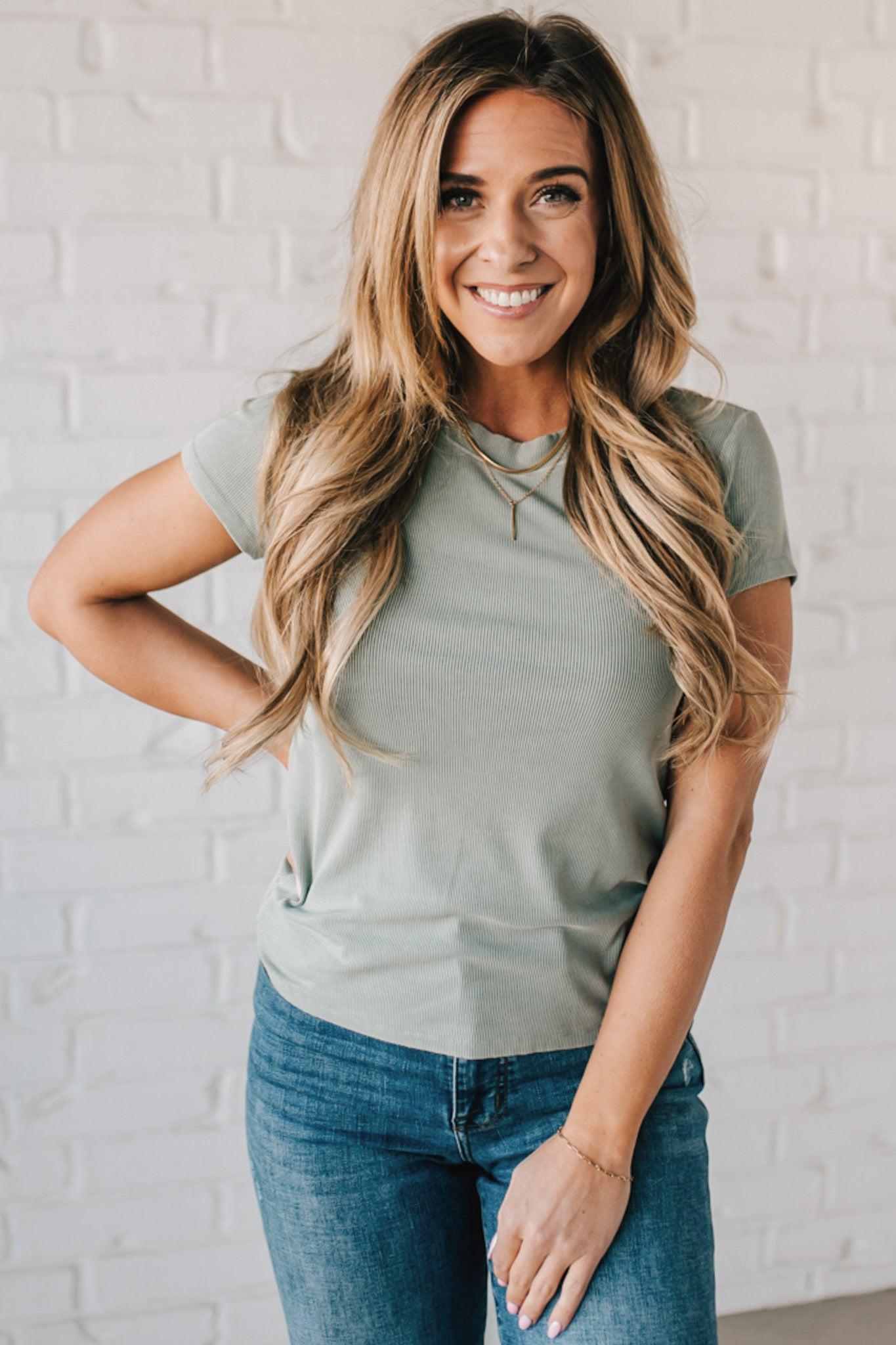 Blonde woman wearing a basic slim fit ribbed tee shirt.