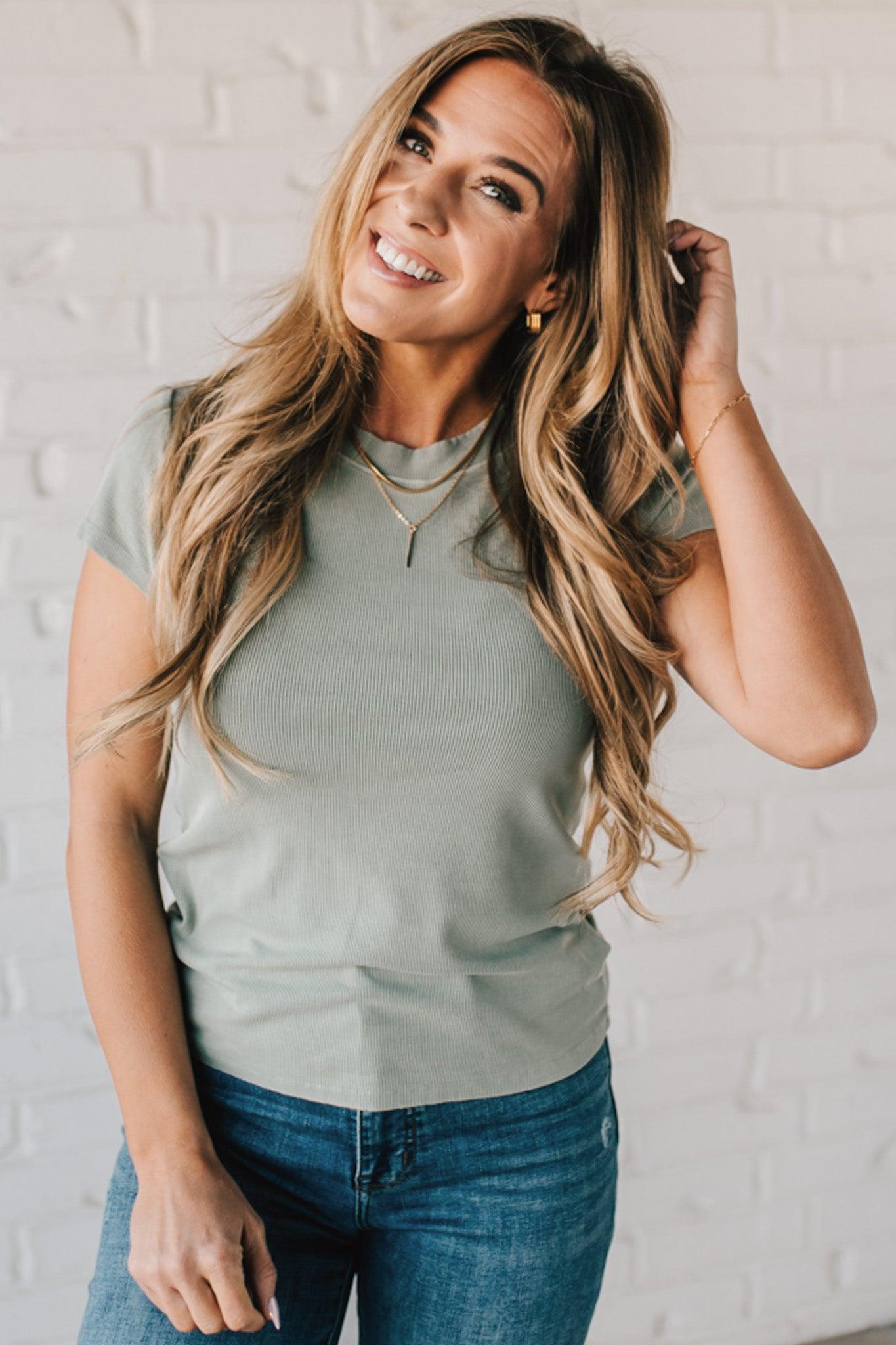 Blonde woman wearing a basic slim fit ribbed tee shirt.