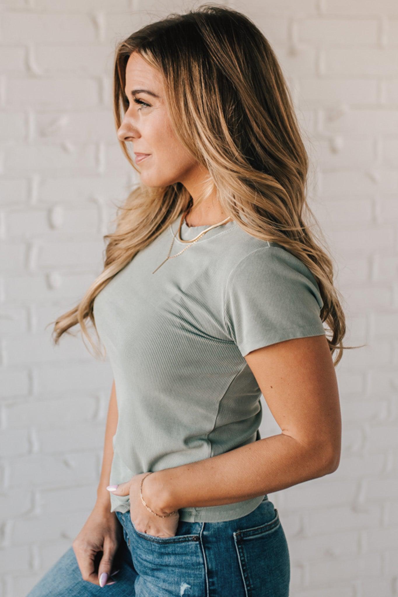Blonde woman wearing a basic slim fit ribbed tee shirt.