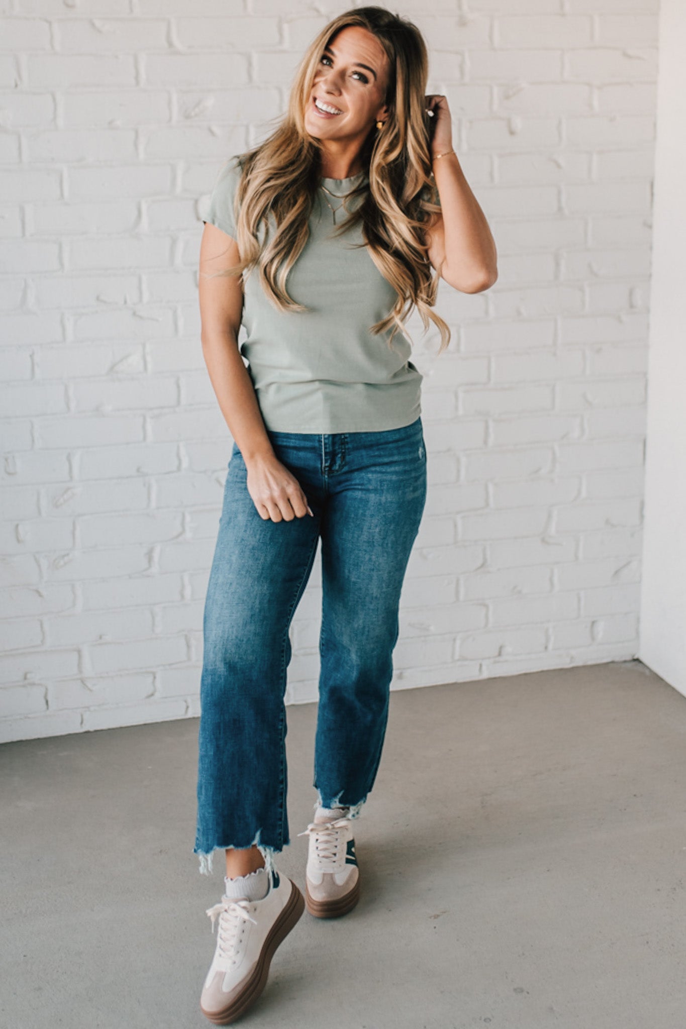 Blonde woman wearing a basic slim fit ribbed tee shirt.