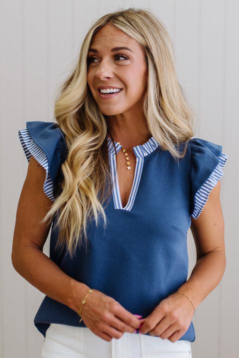 Blonde woman wearing a Striped accent Frill Split Neck Scuba Top