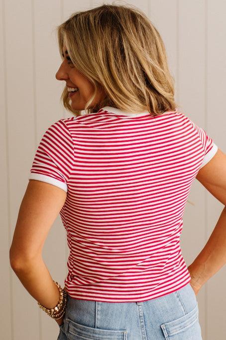 Woman wearing a red and white striped shirt against a neutral background