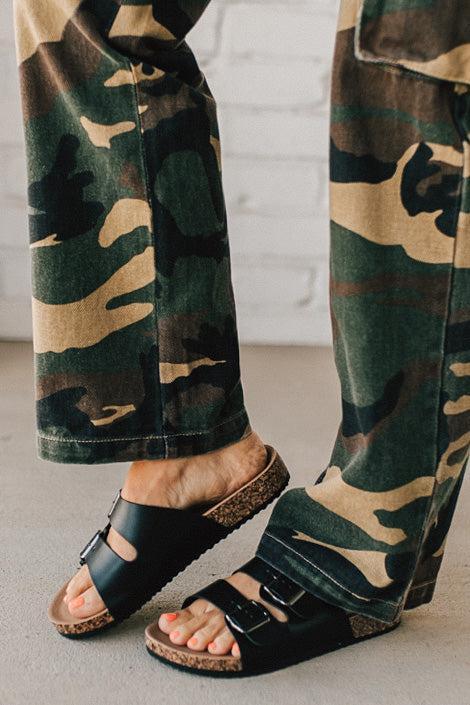 Ladies sandal slides with buckles and cork bottom in black faux leather.