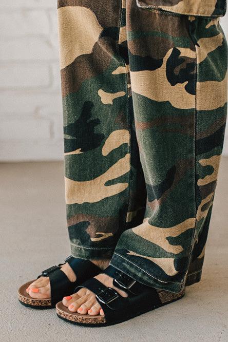 Ladies sandal slides with buckles and cork bottom in black faux leather.