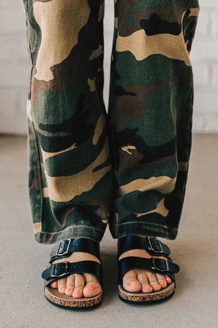 Ladies sandal slides with buckles and cork bottom in black faux leather.