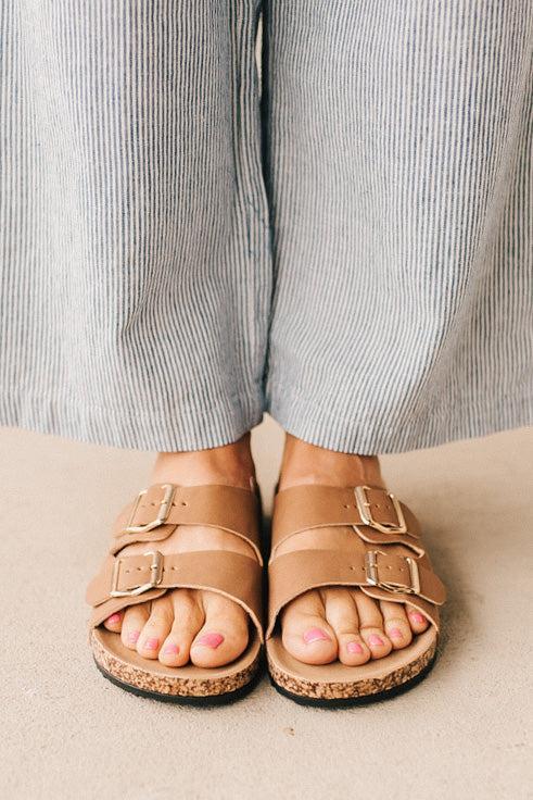 Ladies sandal slides with buckles and cork bottom.
