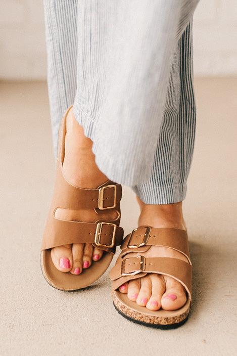 Ladies sandal slides with buckles and cork bottom.