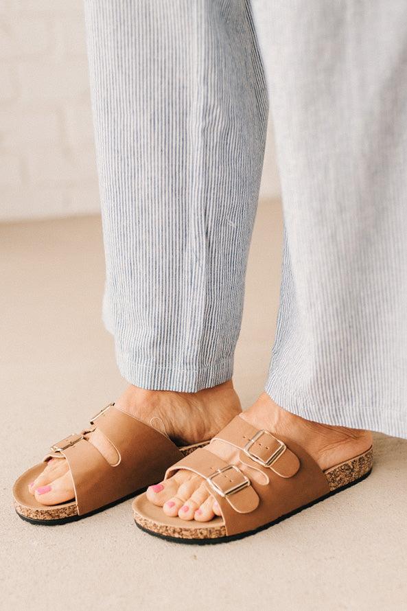 Ladies sandal slides with buckles and cork bottom.