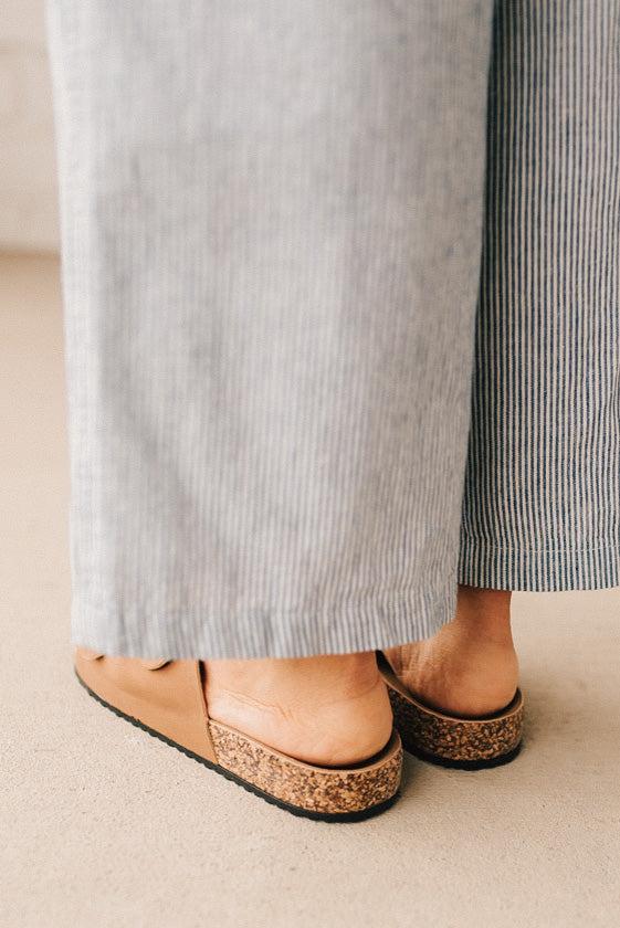 Ladies sandal slides with buckles and cork bottom.