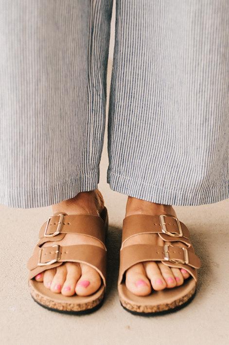 Ladies sandal slides with buckles and cork bottom.