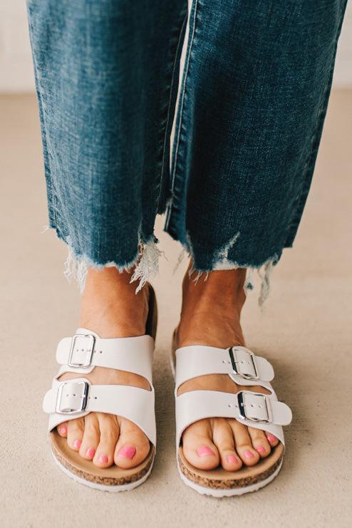 Ladies sandal slides with buckles and cork bottom in white faux leather.