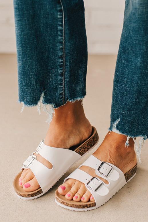 Ladies sandal slides with buckles and cork bottom in white faux leather.