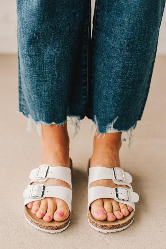 Ladies sandal slides with buckles and cork bottom in white faux leather.