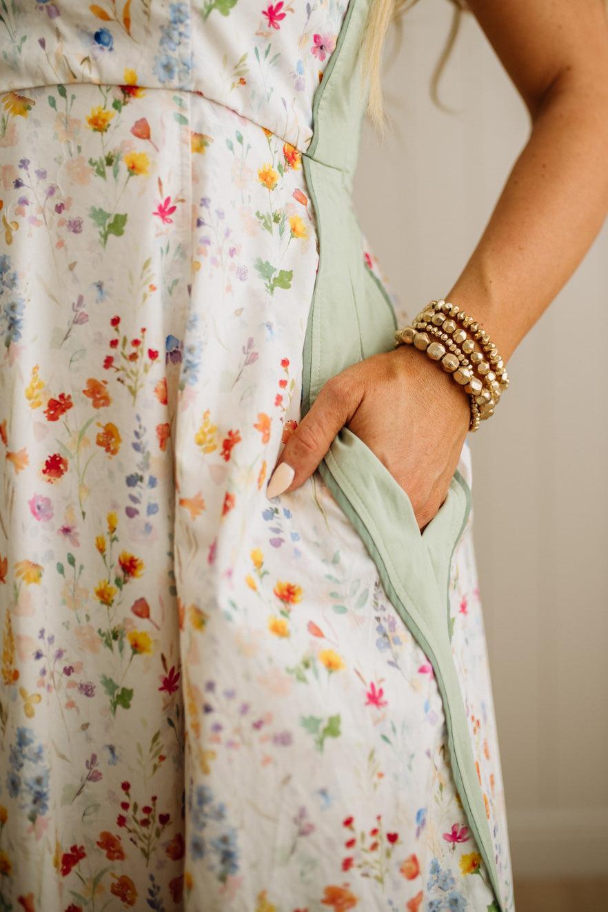 Person wearing a floral dress with a neutral background