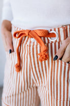 Striped pants with an orange drawstring and white background