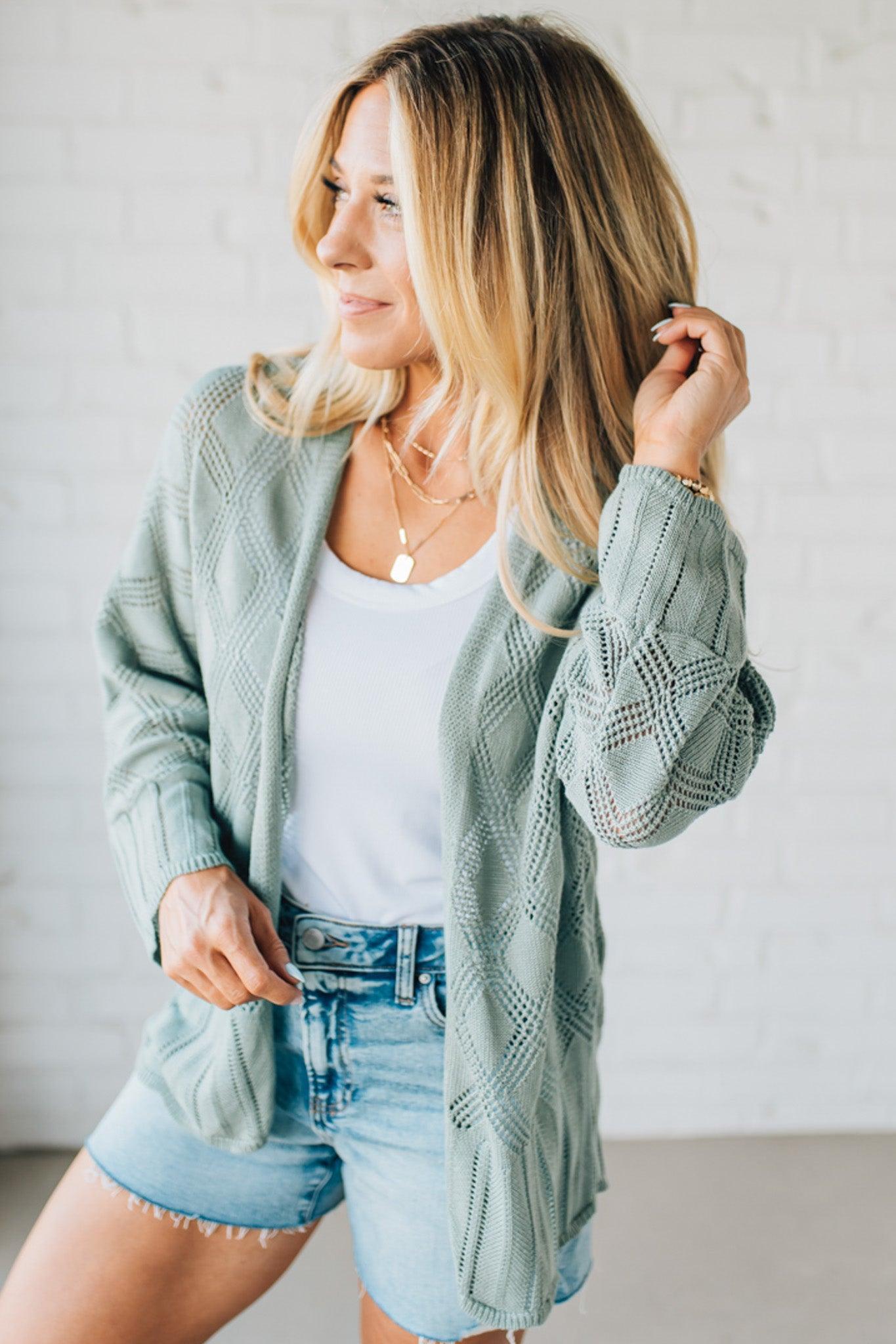 Blonde Model Wearing A Lightweight Crochet Cardigan With Scallop Hem.