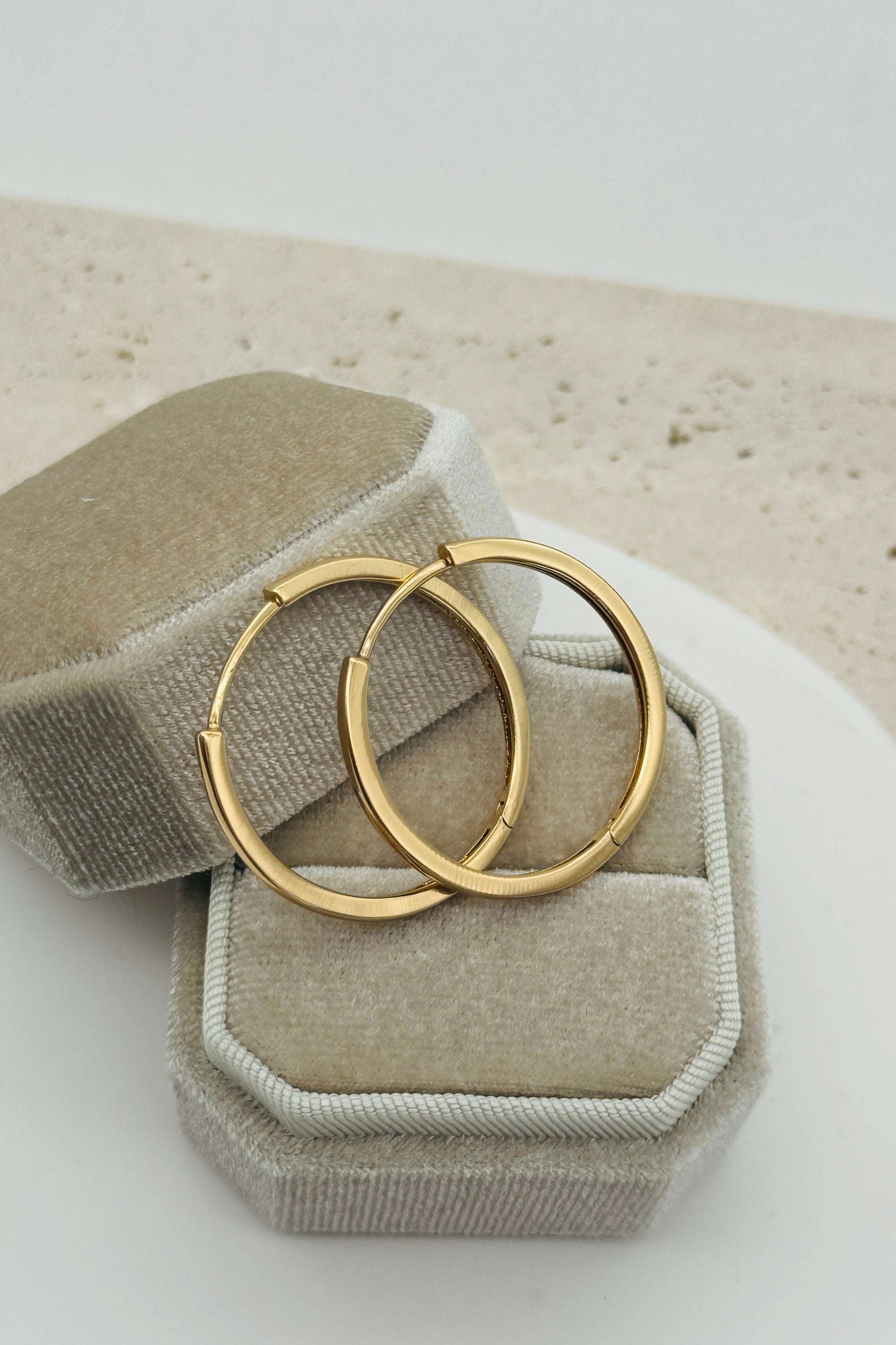 gold hoop earring with blurred background