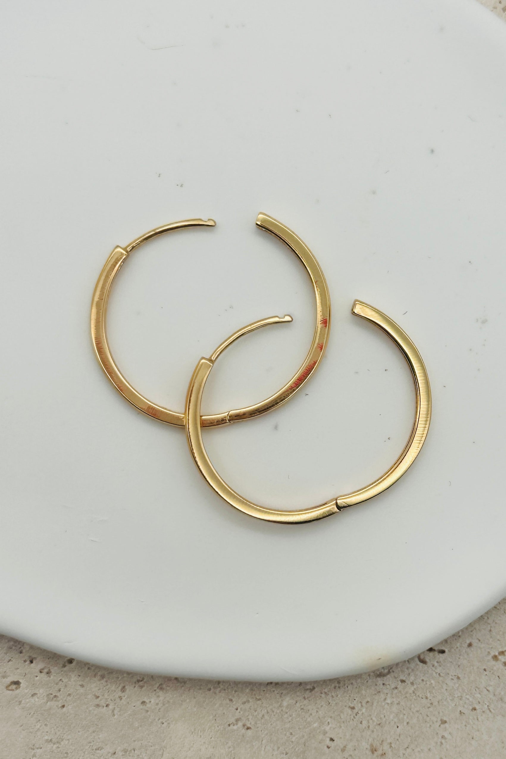 gold hoop earring with blurred background