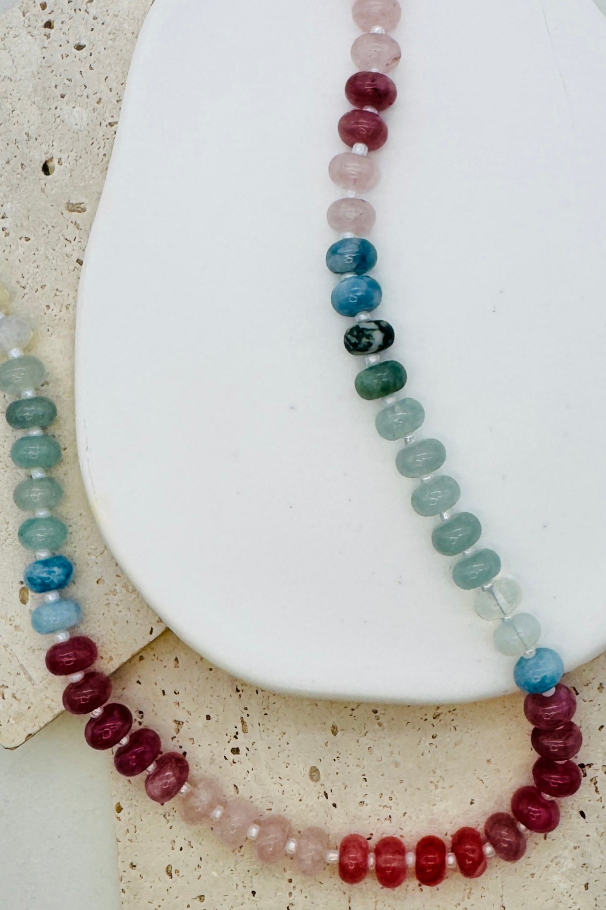 Necklace with multicolored beads on a textured surface