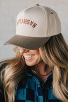 Two tone trucker hat cream and mocha with upside down NASHVILLE embroidery.