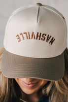 Two tone trucker hat cream and mocha with upside down NASHVILLE embroidery.