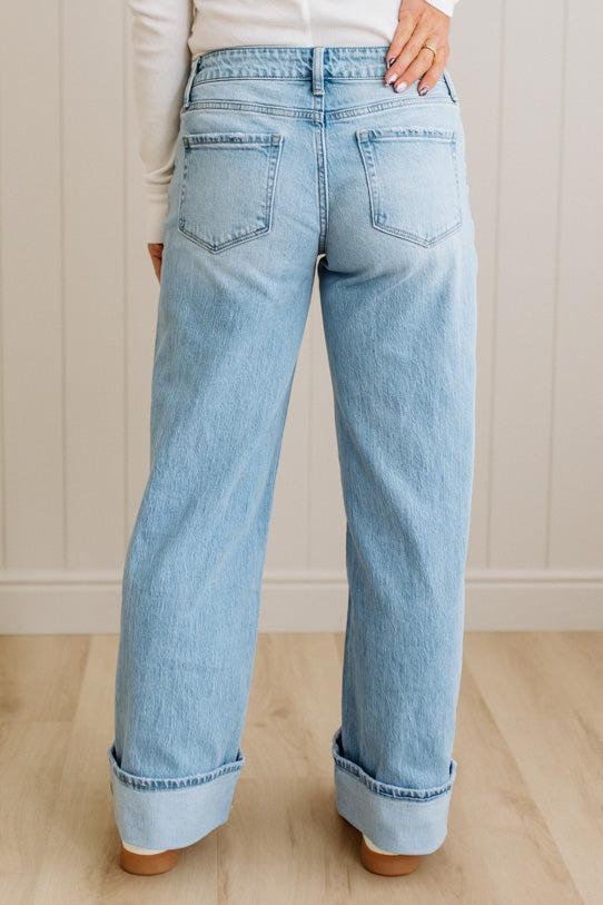 Light blue jeans worn by a person on a neutral background