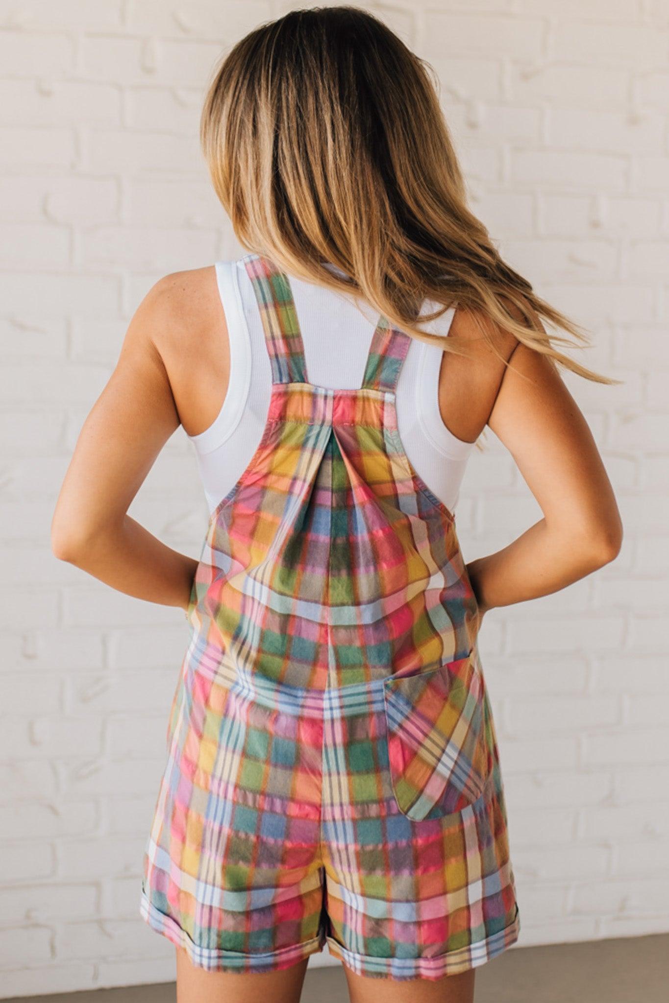 BLONDE WOMAN WEARING MULTI COLOR VINTAGE PLAID WIDE LEG SHORTALLS WITH ADJUSTABLE STRAPS AND WOOD BUTTONS
