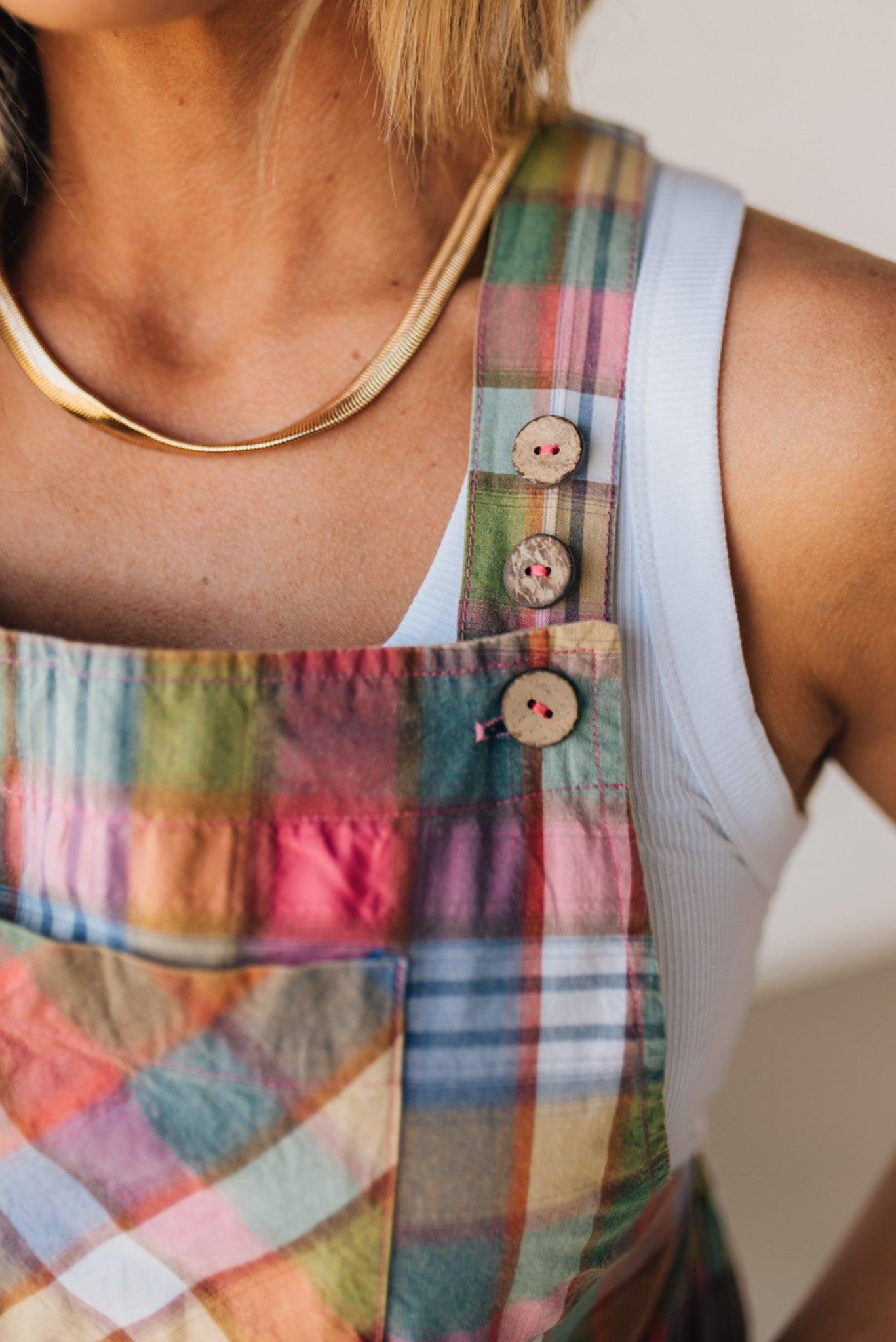 BLONDE WOMAN WEARING MULTI COLOR VINTAGE PLAID WIDE LEG SHORTALLS WITH ADJUSTABLE STRAPS AND WOOD BUTTONS