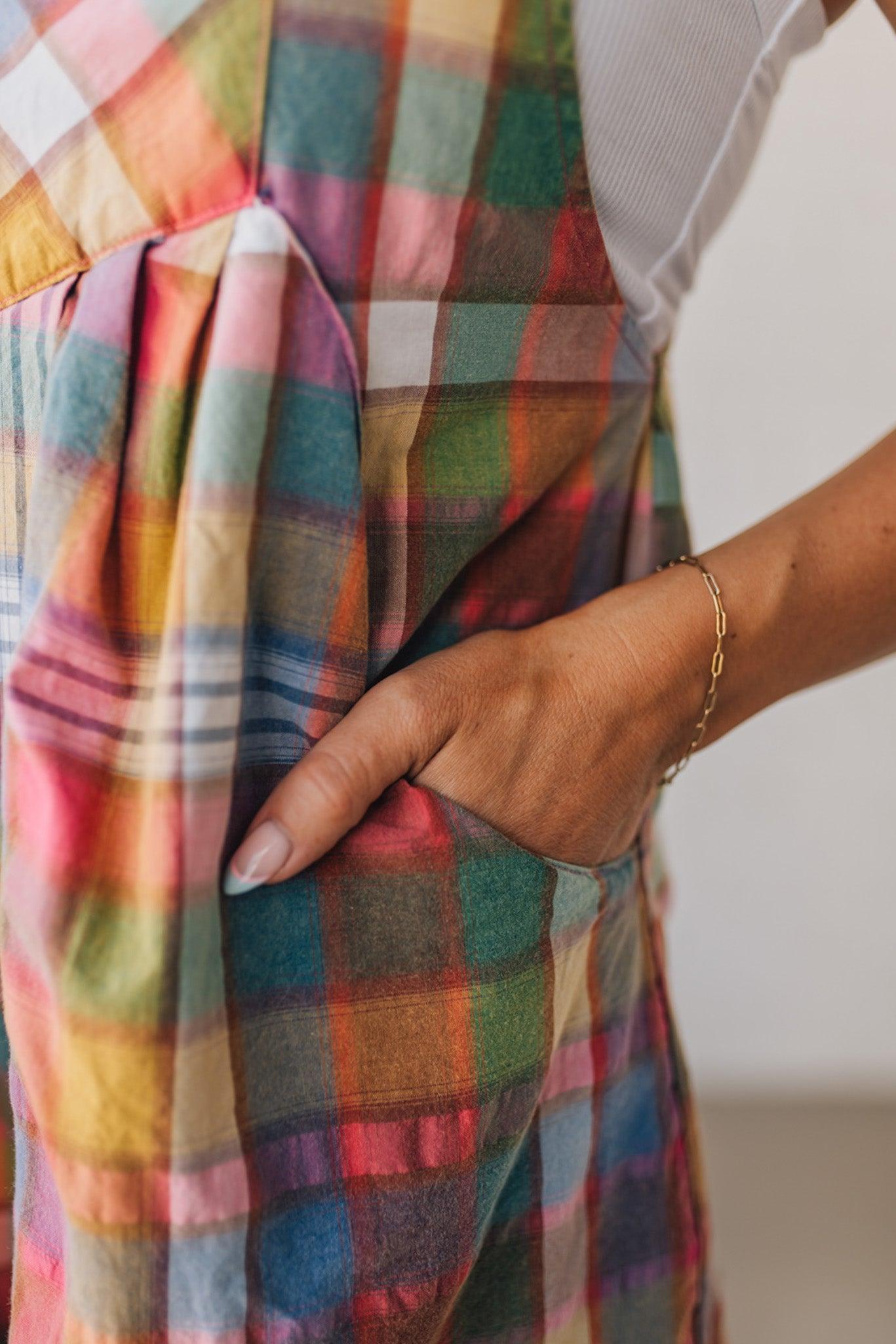BLONDE WOMAN WEARING MULTI COLOR VINTAGE PLAID WIDE LEG SHORTALLS WITH ADJUSTABLE STRAPS AND WOOD BUTTONS