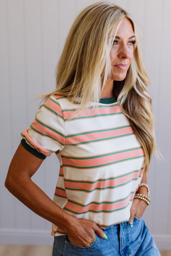 Woman wearing a striped shirt with a neutral background