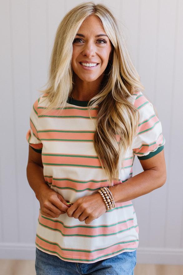 Woman wearing a striped shirt with a neutral background