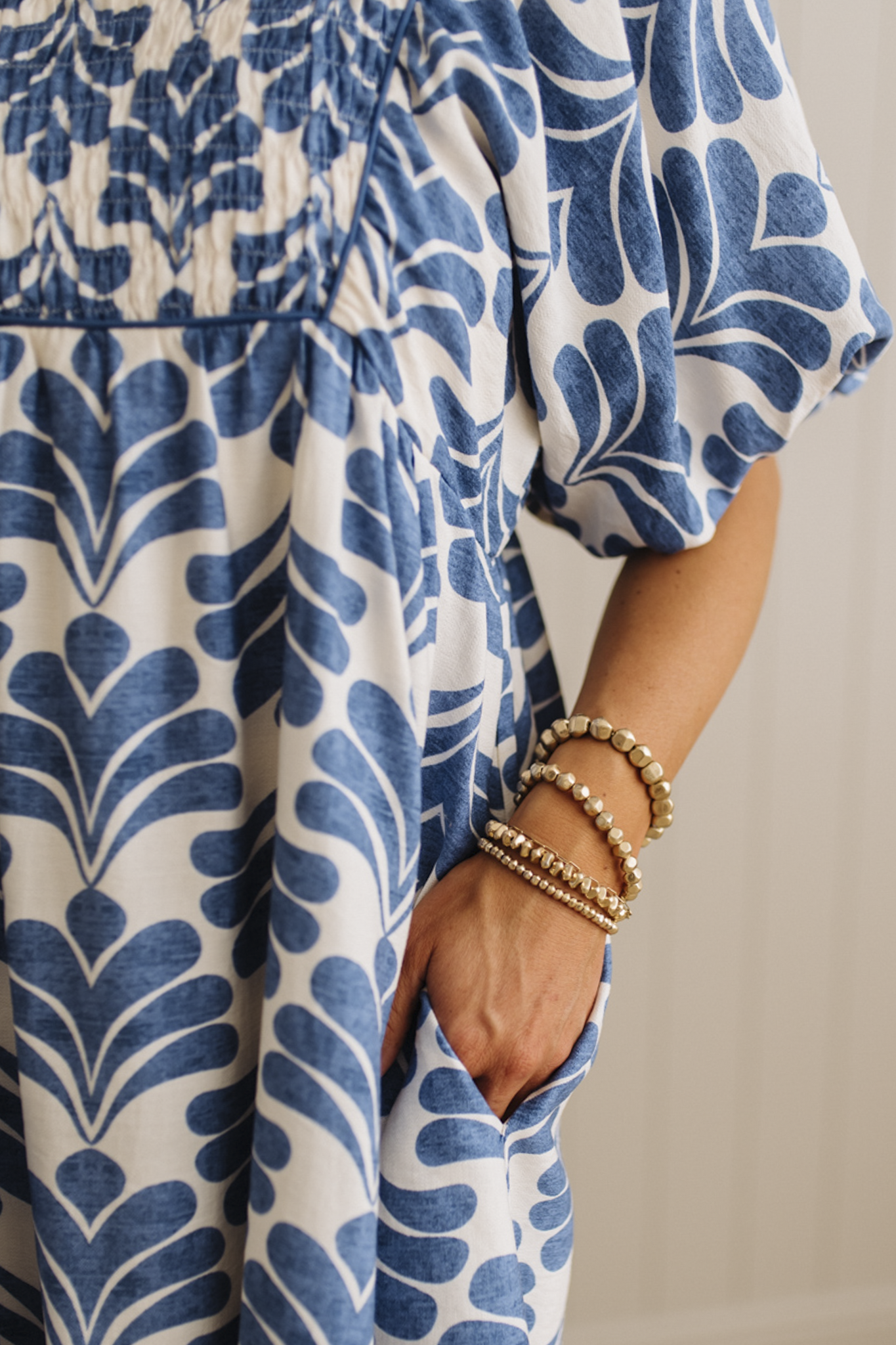 Blue and white patterned dress with a neutral background