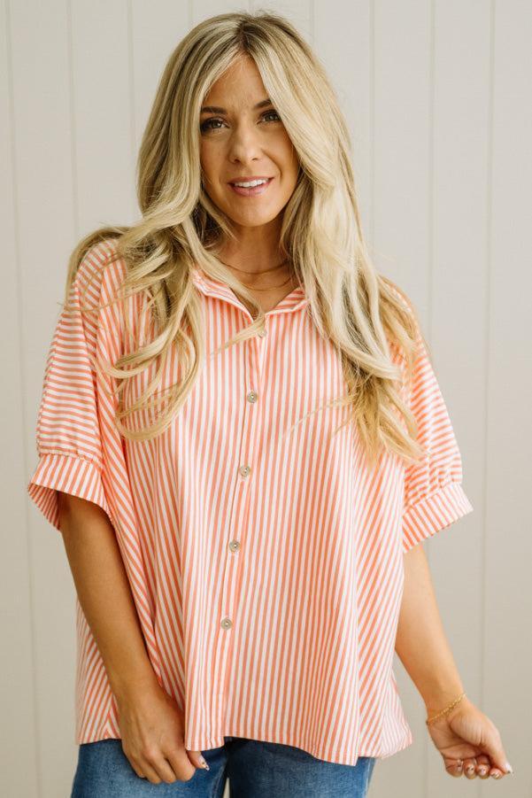 Woman wearing a striped shirt with a neutral background