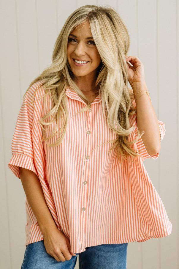 Woman wearing a striped shirt with a neutral background