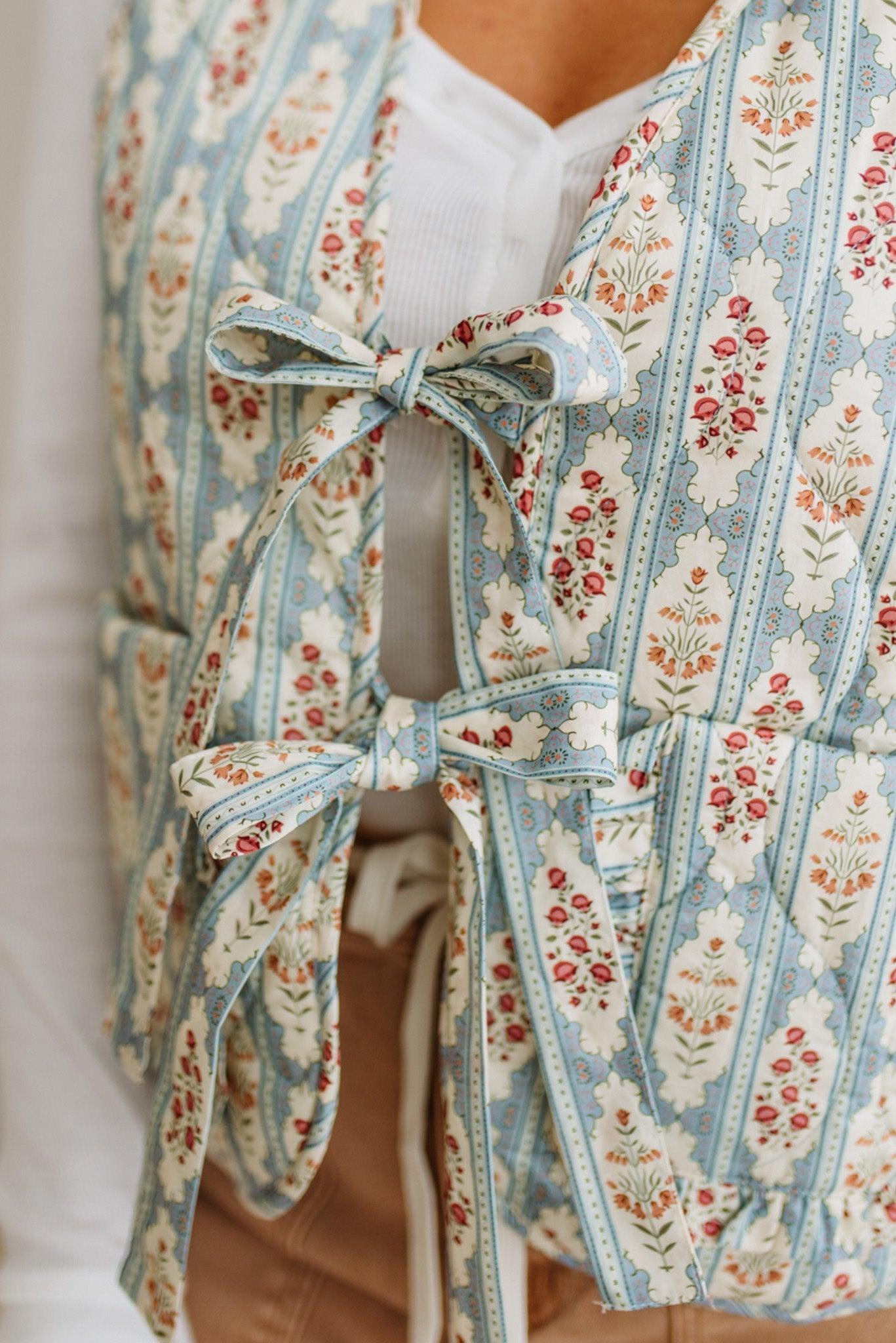 Floral patterned garment with bows on a plain background