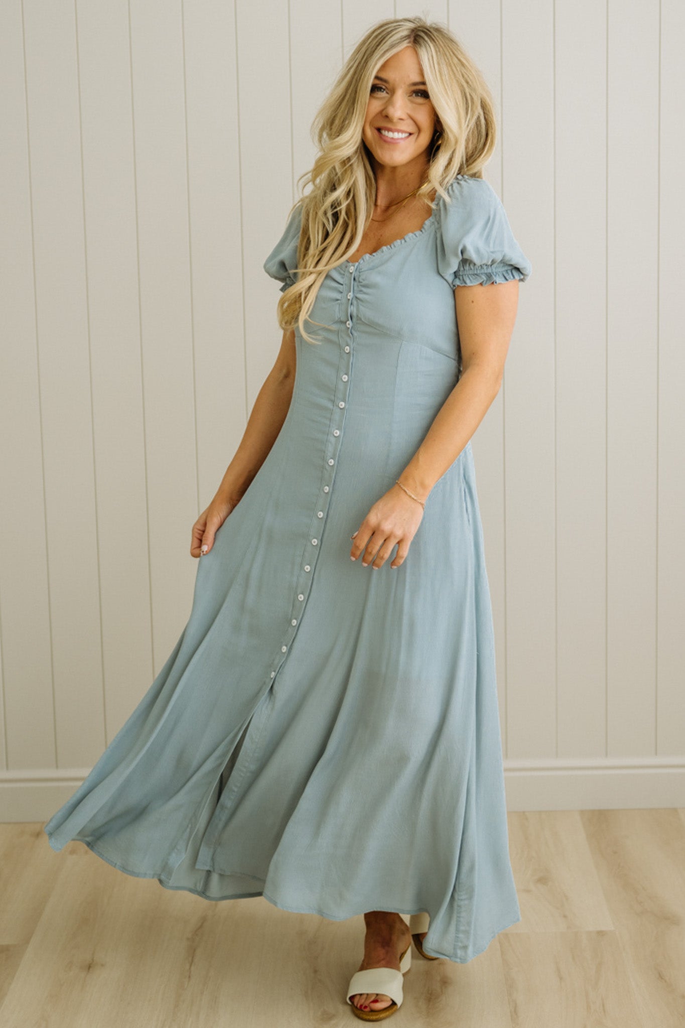 Woman wearing a light blue dress with a white background