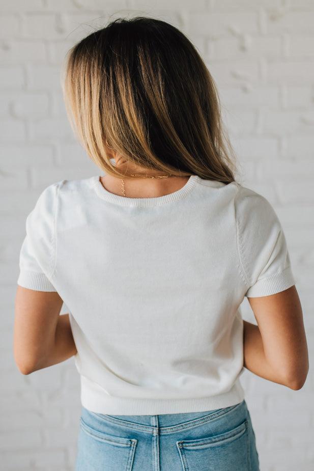 Blonde Woman Wearing a Round Neck Short Sleeve Dog Graphic Sweater.