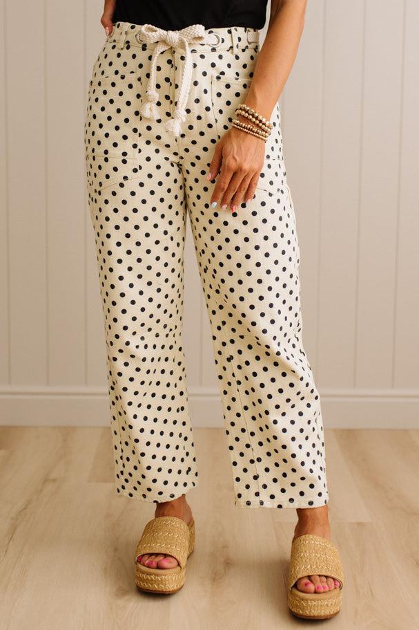 Person wearing polka dot pants with a neutral background