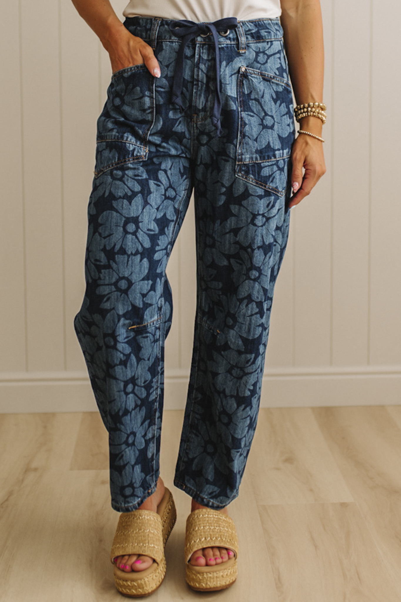 Person wearing blue patterned pants with a neutral background