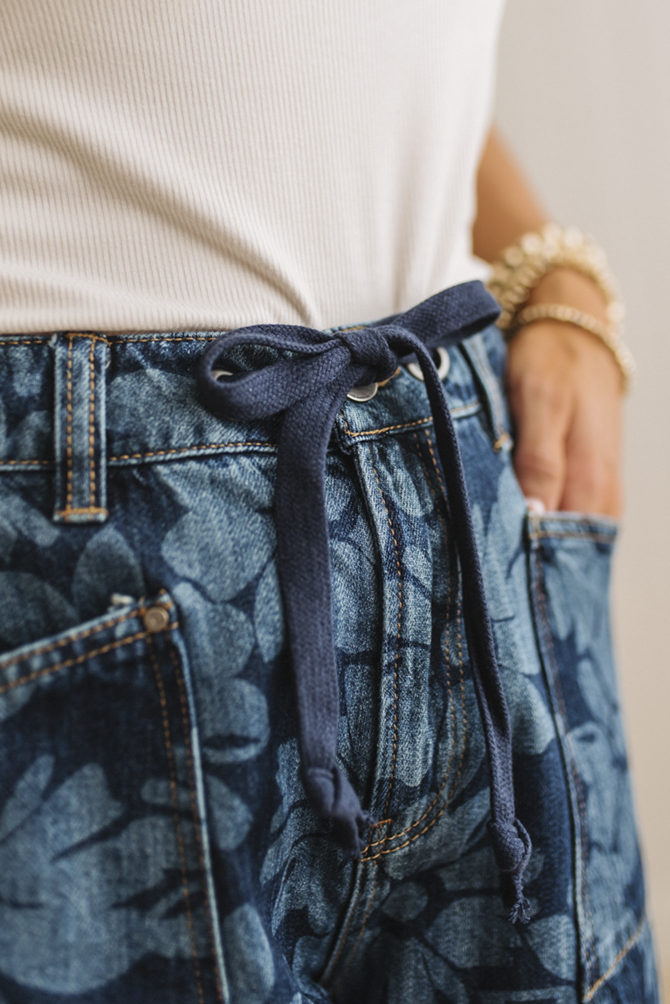 Close-up of blue patterned pants with a drawstring waistband.